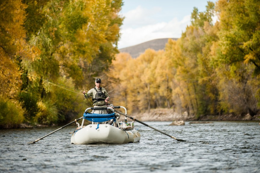 An angler casts from a boat on the Gunnison River
